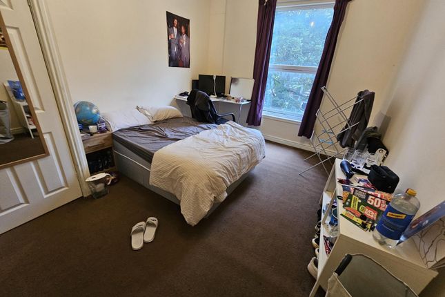 A Cozy Bedroom Featuring A Double Bed, A Window Wi...