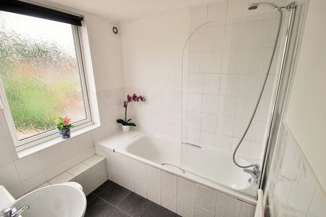 A Modern Bathroom Featuring A Spacious Bathtub And...