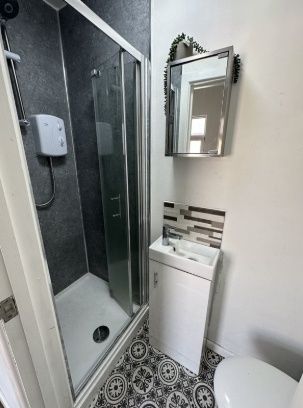 Bright And Modern Bathroom Featuring A Sleek Glass...