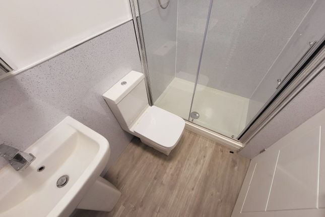 A Modern Bathroom Featuring A Sleek Shower And Con...
