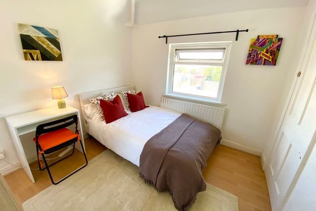 This Charming Double Bedroom Features A Cozy Ambia...
