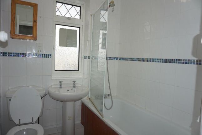 A Tidy And Functional Bathroom Featuring A Bathtub...