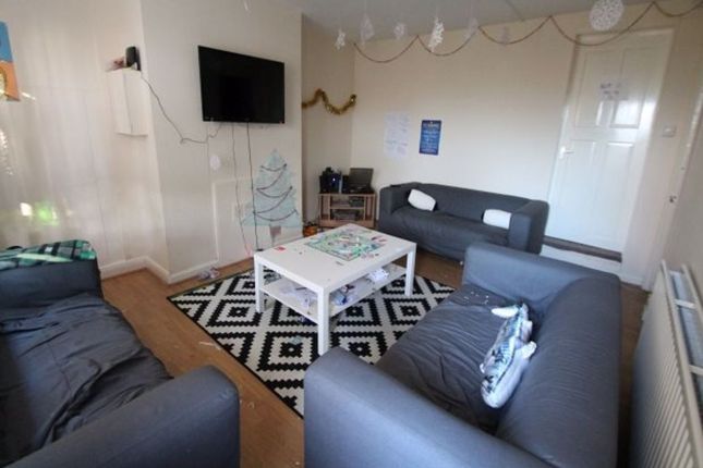 A Spacious And Well-Lit Living Room Featuring Comf...