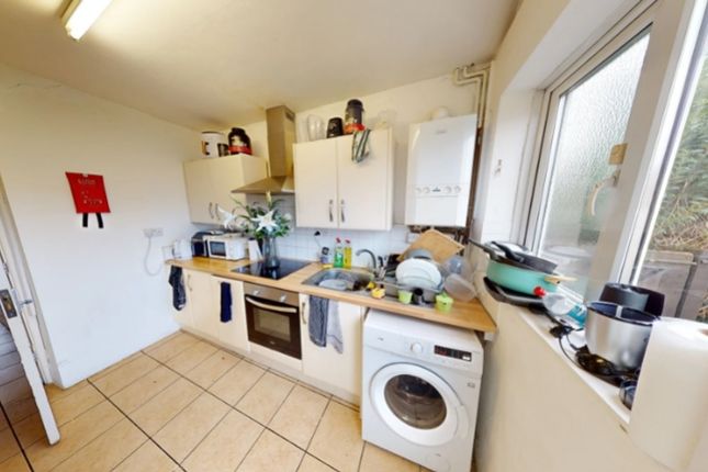 A Functional Kitchen Equipped With Essential Appli...