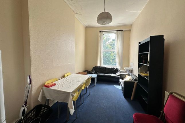 A Spacious And Bright Living Room With Ample Seati...