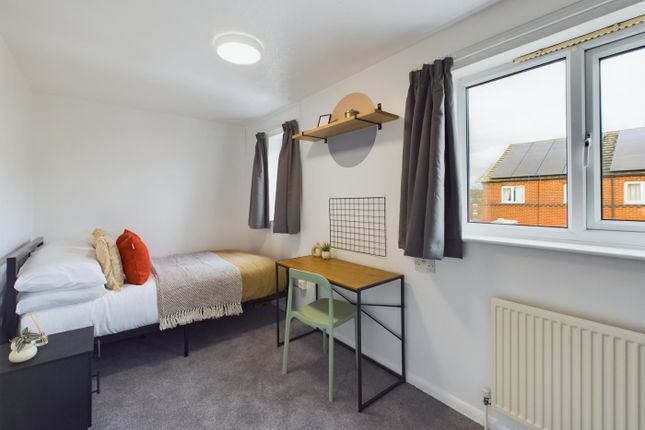 A Bright And Tidy Double Bedroom Featuring A Comfo...
