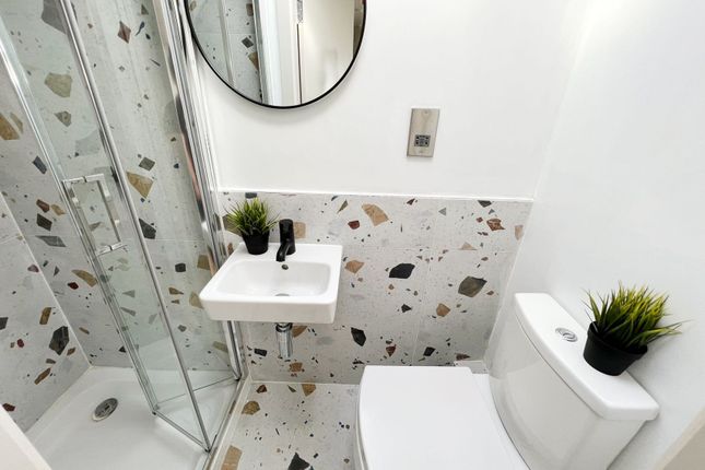 A Modern Bathroom With A White Toilet And A Small ...