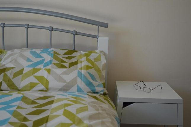 A Tidy Single Bedroom Featuring A Neatly Made Bed ...