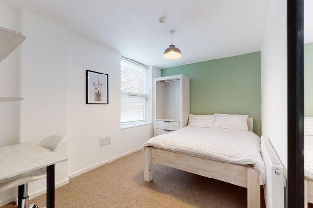A Bright And Inviting Double Bedroom With A Cozy A...
