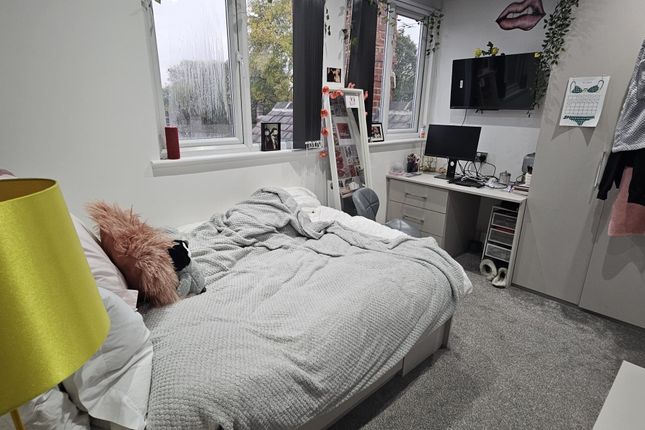 A Bright And Tidy Bedroom Featuring A Comfortable ...