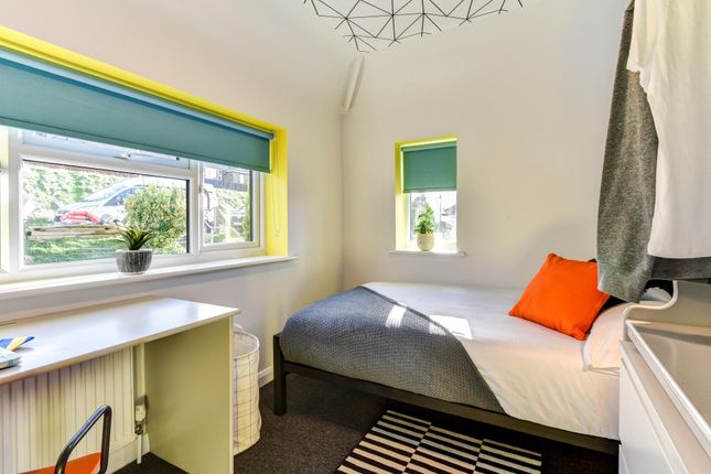 This Cozy Double Bedroom Features Large Windows Th...