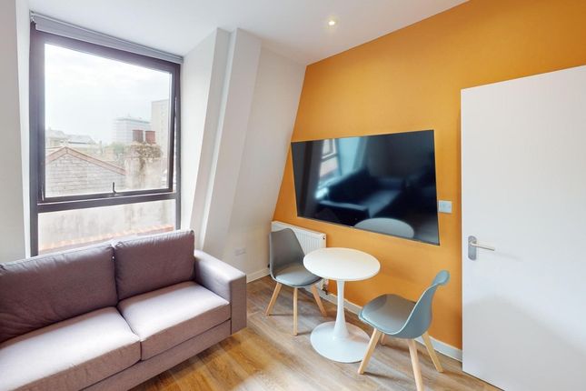 A Bright And Welcoming Living Room Featuring Moder...