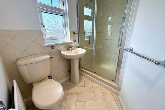 A Bright And Clean Bathroom Featuring A Modern Sho...