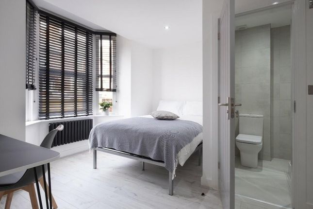 A Bright And Modern Master Bedroom Featuring A Com...