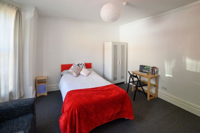 A Cozy Single Bedroom Featuring A Neatly Made Bed ...