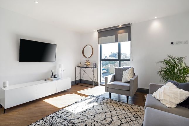 Bright And Modern Living Room Featuring A Large Wi...