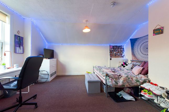 A Bright And Cozy Bedroom With A Comfy Bed, A Stud...
