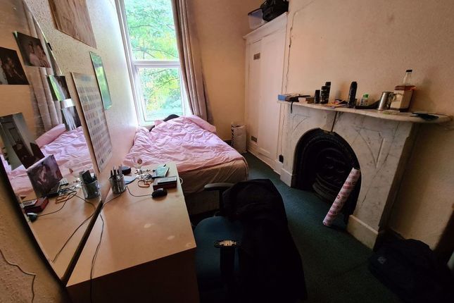 Cozy Bedroom Featuring A Large Window Providing Na...