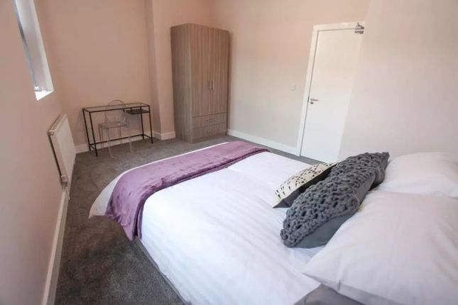 A Bright And Tidy Master Bedroom Featuring A Comfo...
