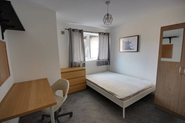 A Bright And Tidy Double Bedroom Featuring A Desk ...