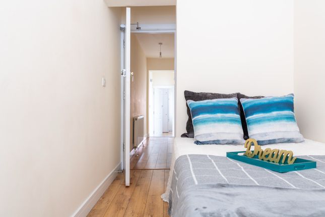 This Charming Double Bedroom Features A Cozy Atmos...