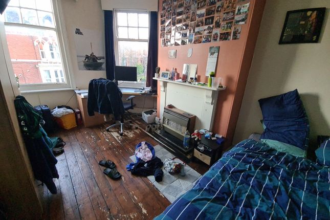 A Cozy Single Bedroom Featuring A Large Window Tha...