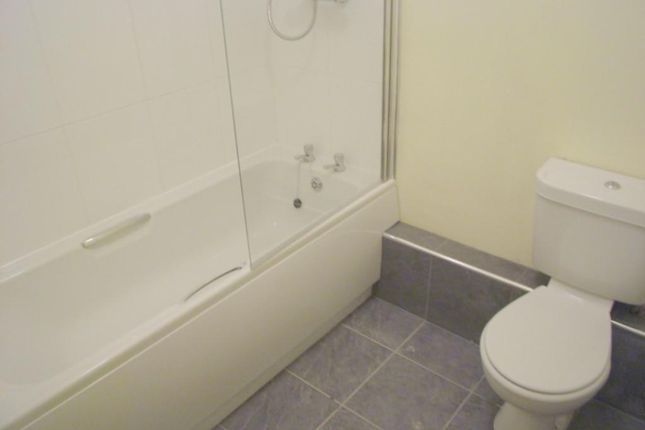 A Well-Maintained Bathroom Featuring A Modern Bath...