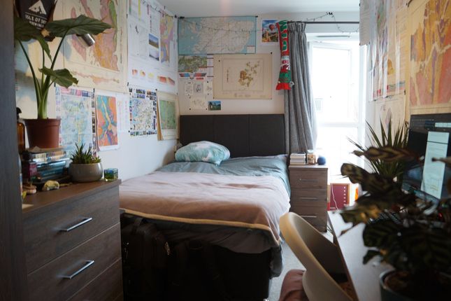 A Cozy, Well-Decorated Single Bedroom Featuring A ...
