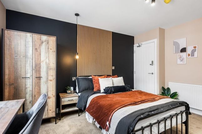 A Stylish Double Bedroom Featuring A Cozy Bed With...