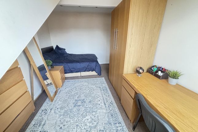 A Neat And Cozy Single Bedroom Featuring A Bed, A ...