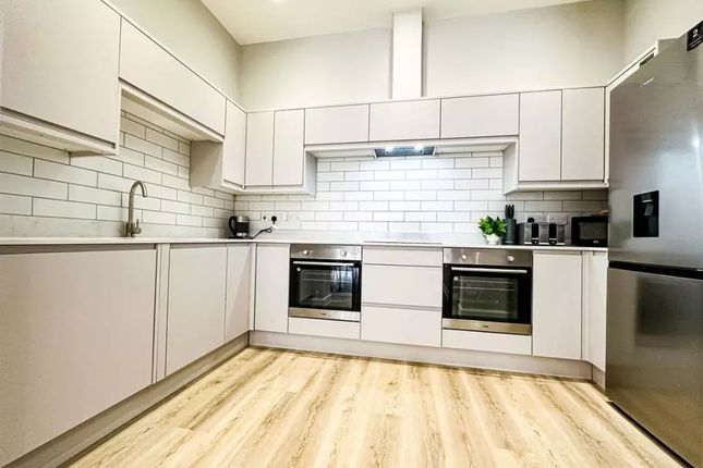Bright And Modern Kitchen Featuring Sleek White Ca...