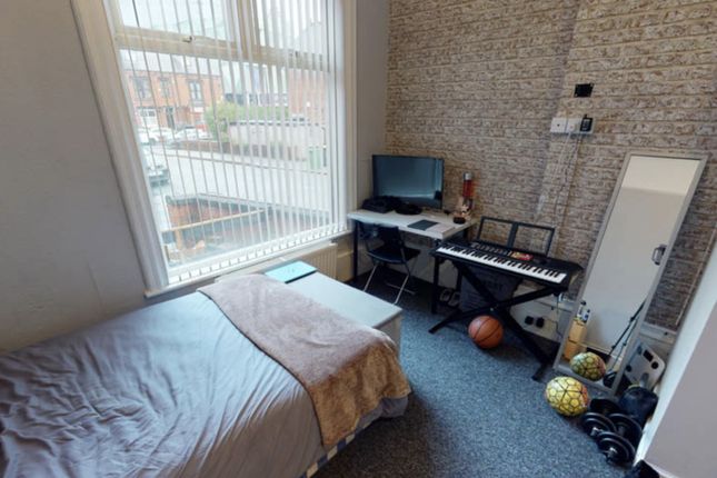 A Cozy Bedroom Featuring A Single Bed Next To A La...