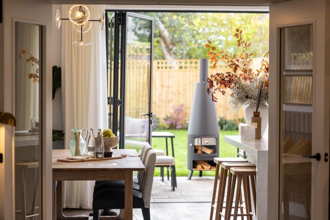 Kitchen Opening Onto A Private Garden Through Bi-Folding Doors