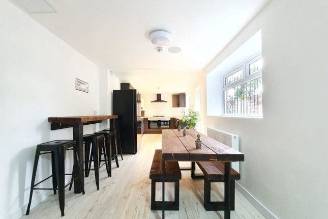 A Bright And Spacious Kitchen Area With Modern Fur...