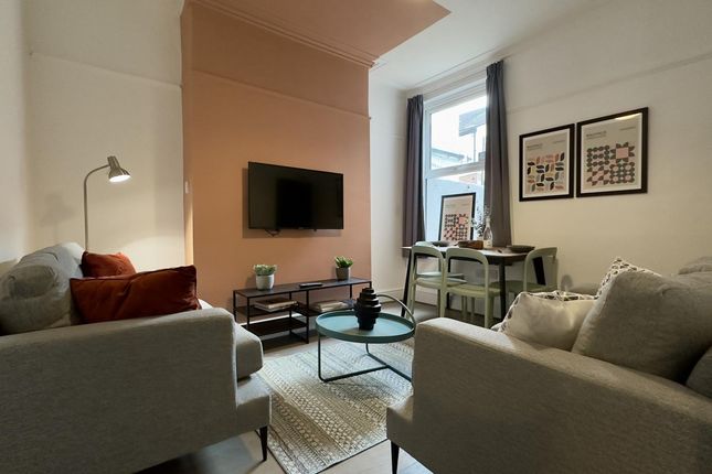 A Spacious And Stylish Living Room With Modern Dec...