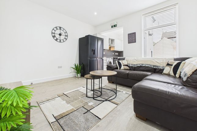 Bright And Spacious Living Room Featuring Comforta...