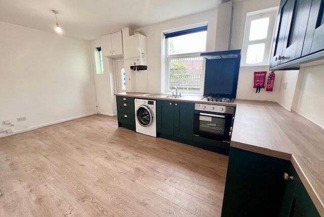 Bright And Modern Kitchen Featuring Ample Counter ...