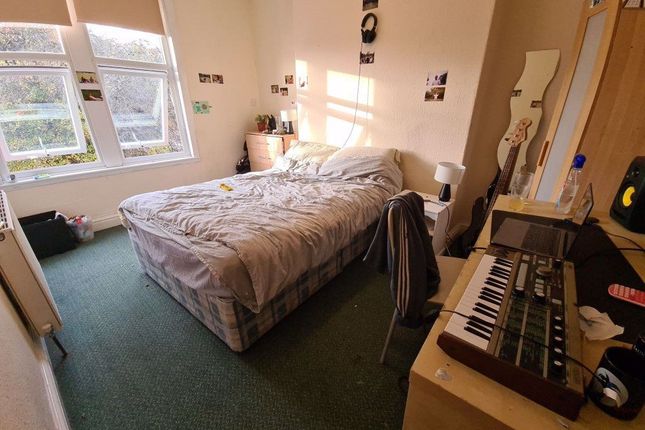 A Well-Lit Double Bedroom Featuring A Cozy Bed Pos...