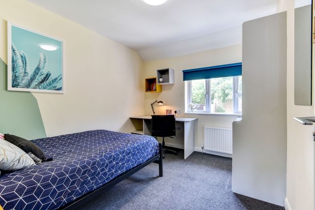 This Inviting Double Bedroom Features A Cozy Layou...