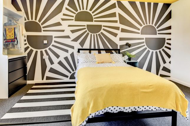 This Vibrant Double Bedroom Features A Stylish Des...