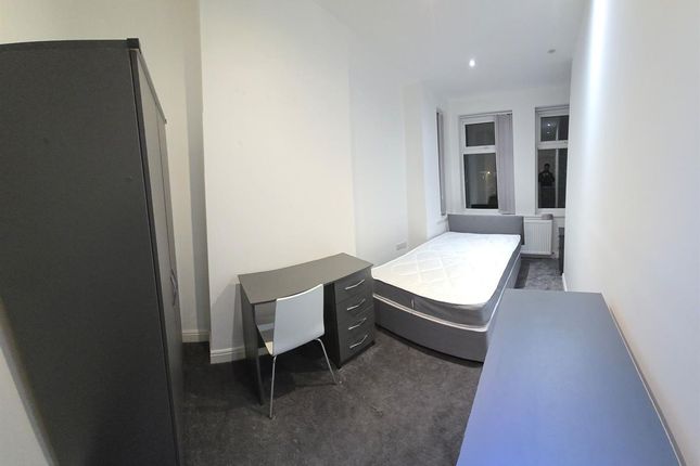 A Bright And Tidy Bedroom Featuring A Comfortable ...