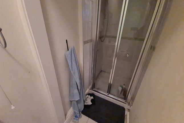 A Compact Bathroom Featuring A Shower Enclosure Wi...