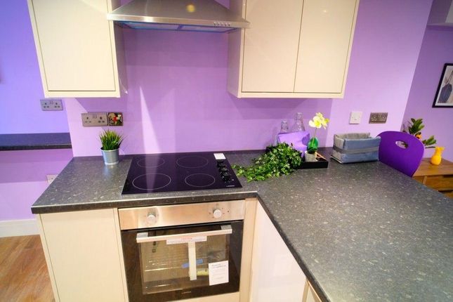 A Modern Kitchen Featuring Purple Walls And Sleek ...