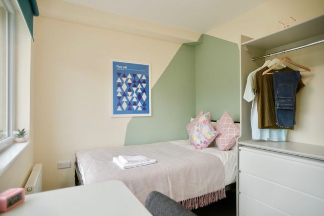 Bright And Tidy Single Bedroom Featuring A Comfort...