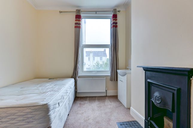 A Cozy Bedroom Featuring A Double Bed, A Window Wi...