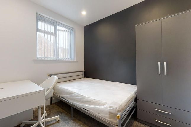 A Neat And Modern Single Bedroom Featuring A Comfo...