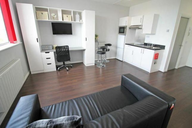 This Stylish Double Bedroom Features A Cozy Seatin...