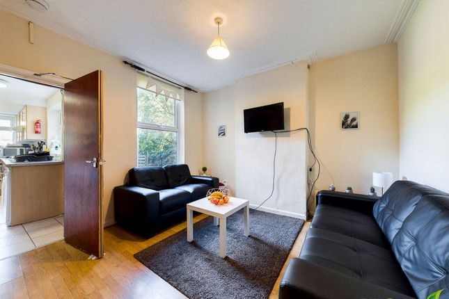 Bright Furnished Living Room With Two Black Leathe...