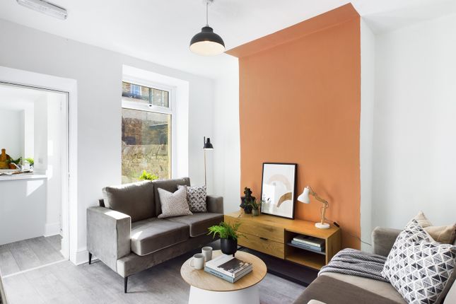 A Stylish And Spacious Living Room Filled With Nat...