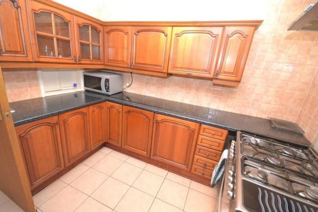 This Charming Kitchen Features Classic Wooden Cabi...